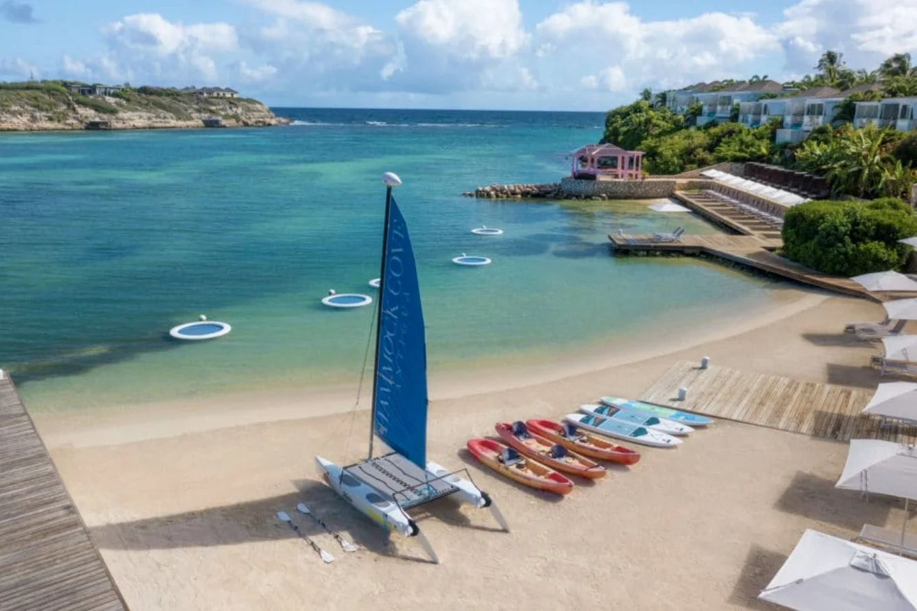 The beach with kayaks and a Hobie Cat ready to go
