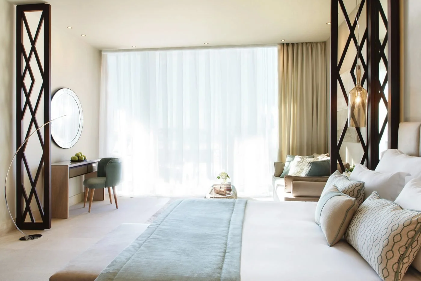 Bedroom of a Deluxe Family Suite at Sani Dunes, with sheer curtains across a wall of windows