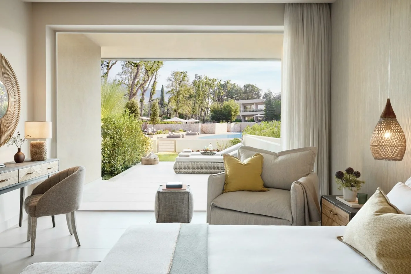 A Superior Double Room Private Garden opening onto a terrace with a daybed, garden and pool