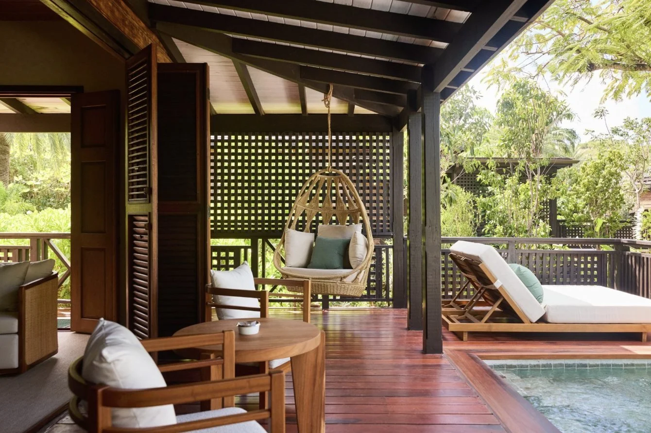 A veranda with daybed beside a private pool