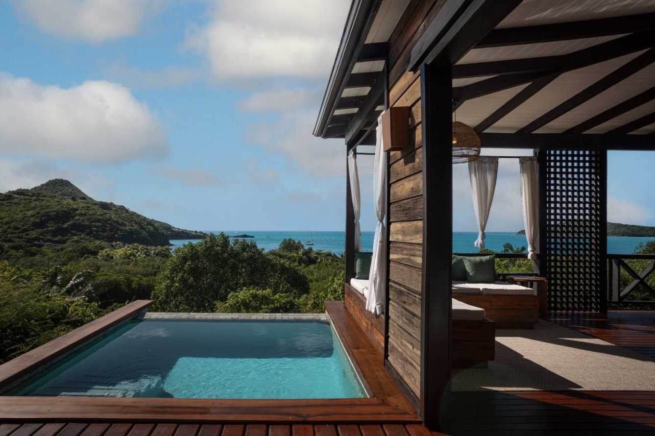 A private plunge pool and shaded deck looking out to sea at Hermitage Bay
