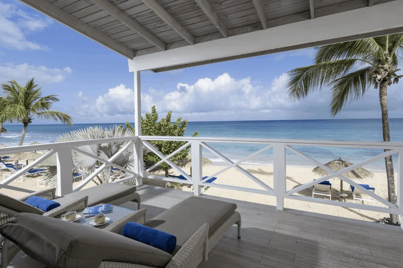 A balcony looking over the beach and sea