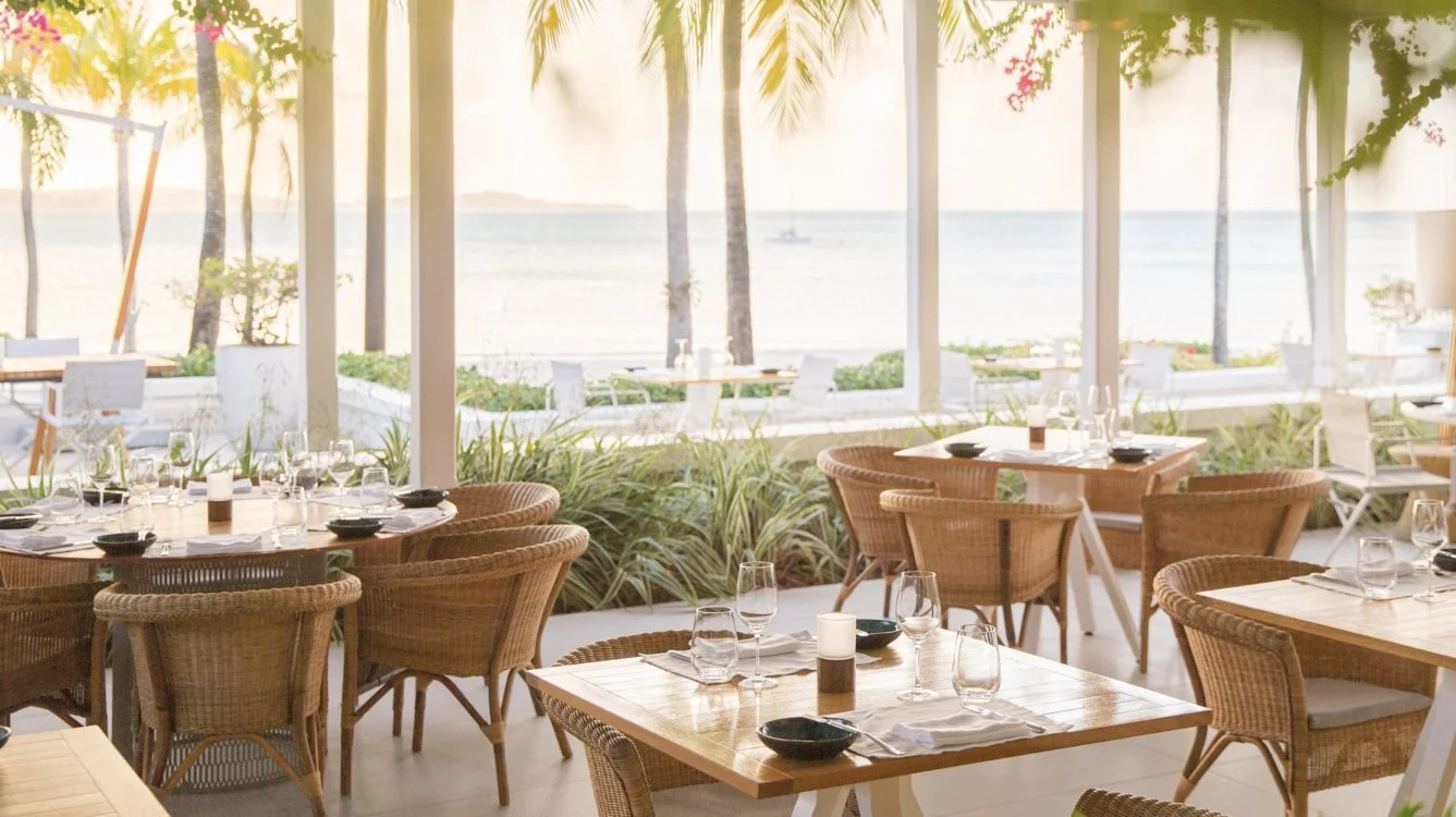 Open-air tables at The Veranda looking out to sea