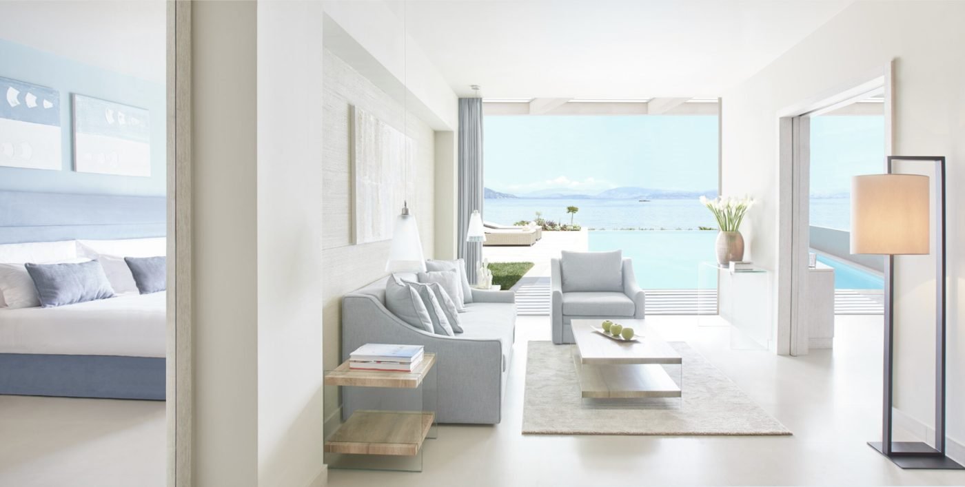 The terrace of a Deluxe Two Bedroom Suite Private Pool Beachfront, with wicker chairs beside its own pool and the Ionian Sea beyond