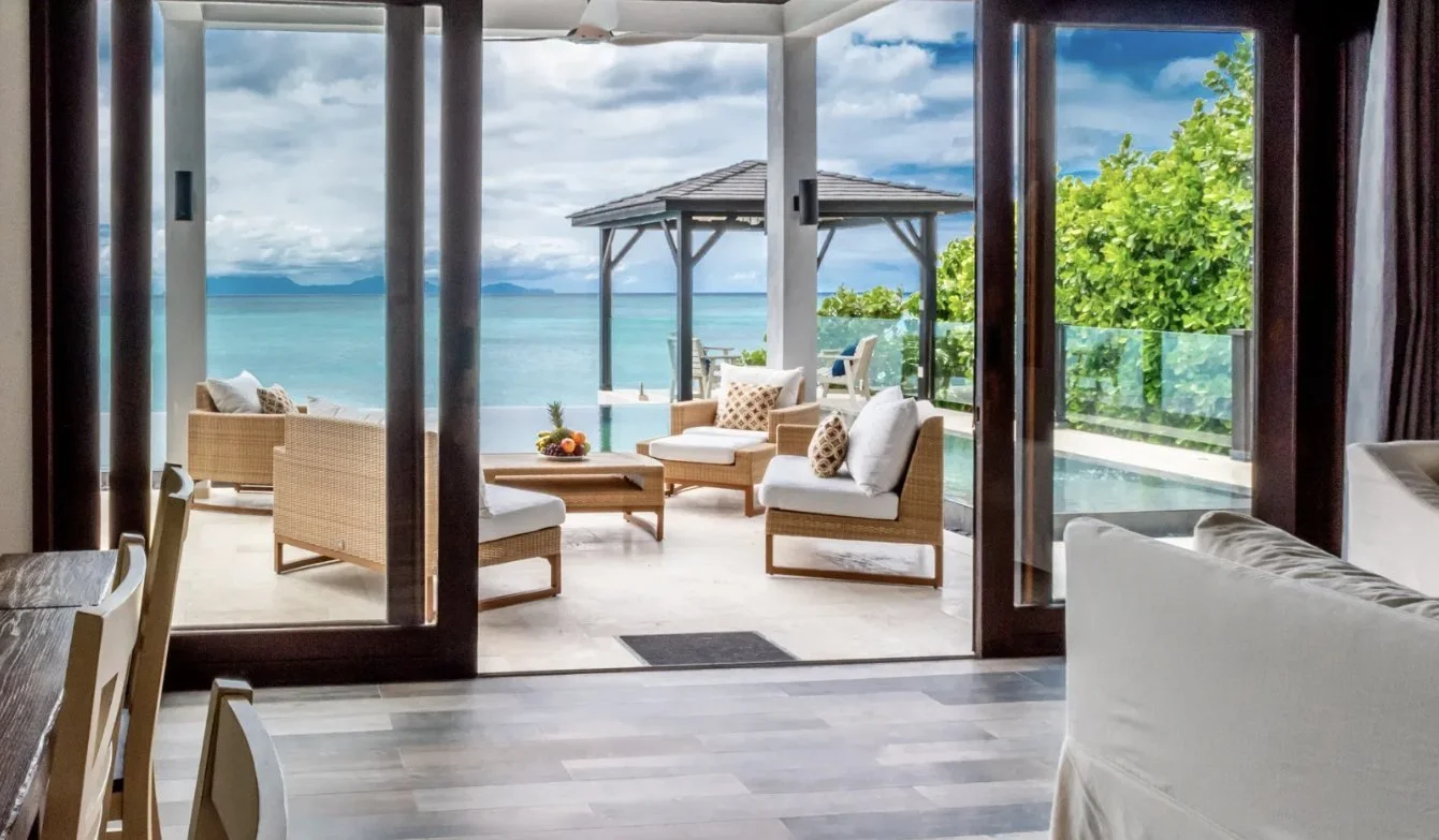 A villa living area opening onto a terrace with sea views