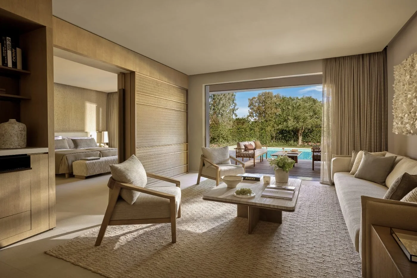 Living room of a three-bedroom villa at Sani Asterias opening onto a private pool and garden
