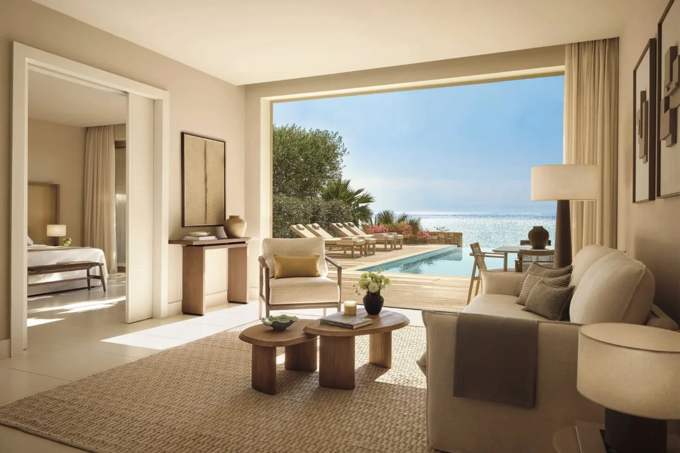 The living room of a two-bedroom suite at Sani Club opening onto a private pool and the sea