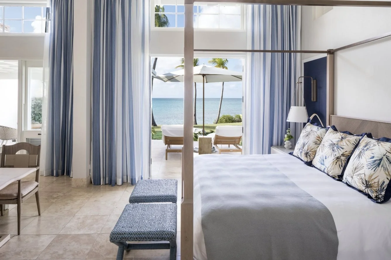 A cottage bedroom opening onto a sea-view terrace