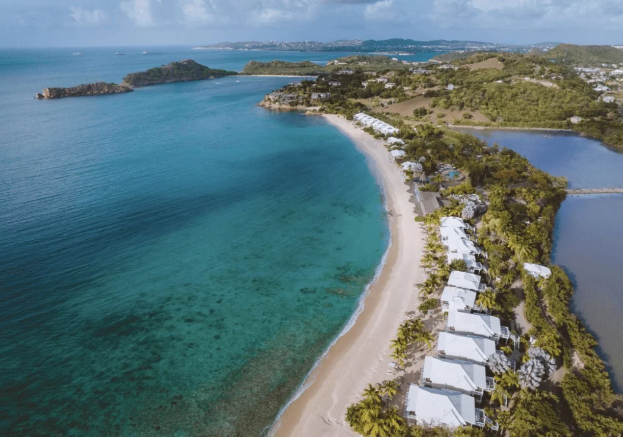 Aerial view of Galley Bay's long beach with the lagoon behind