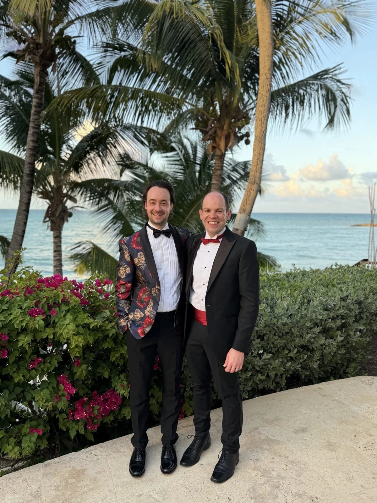 Ben and Hugh in black tie under the palms at Blue Waters, ready for the 2025 Black Pineapple Awards