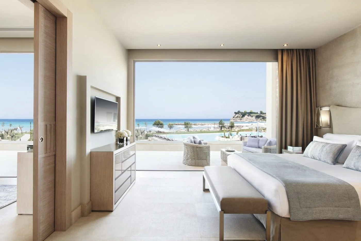 Bedroom of a Deluxe One Bedroom Suite at Sani Dunes with glass pendant lights and lattice screens