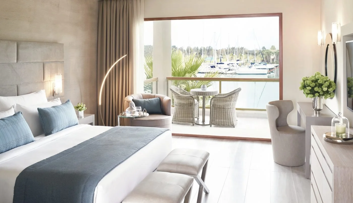 A Marina Double at Sani Dunes, with a balcony table and chairs looking over the yachts in Sani Marina