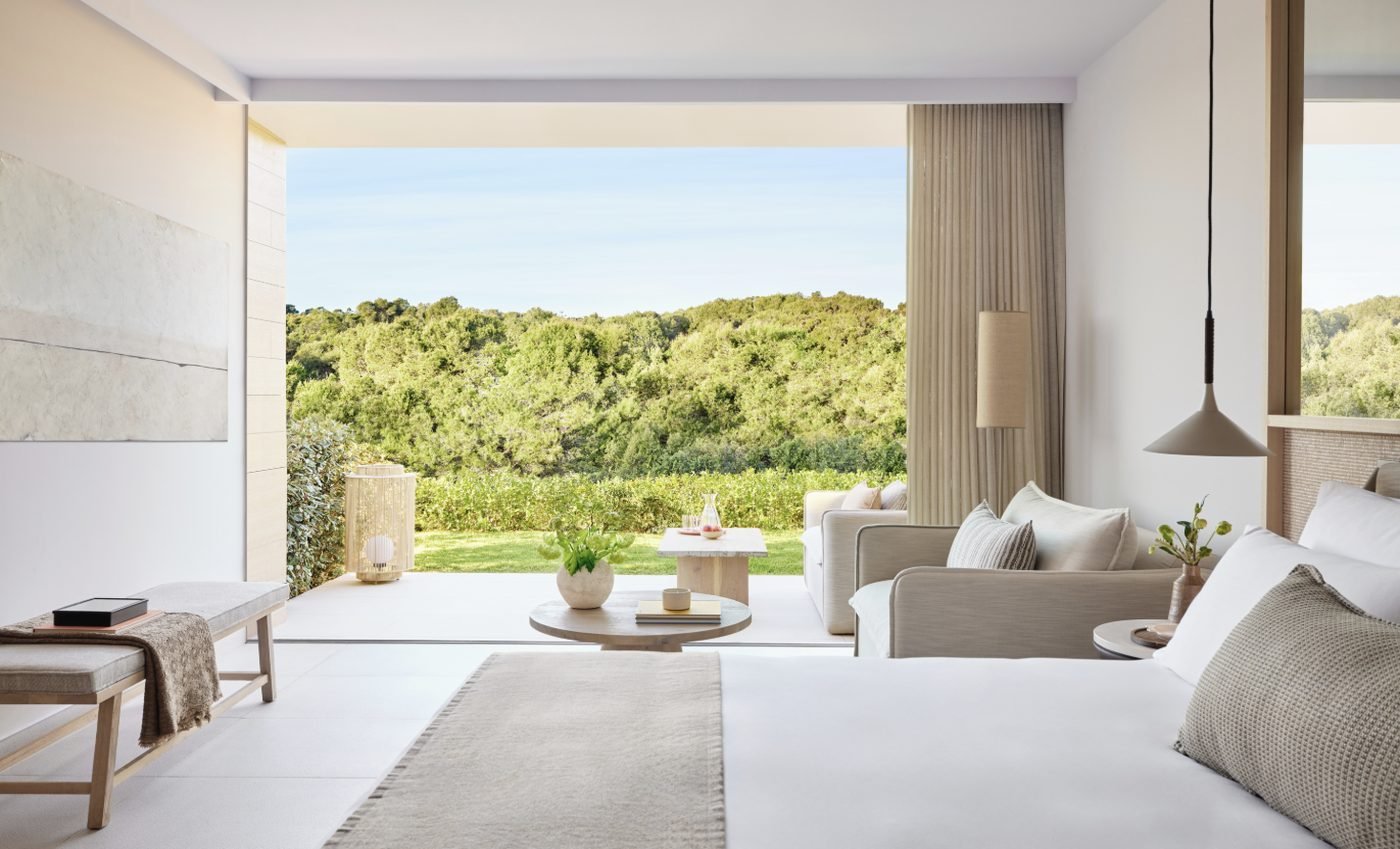A Superior Double Room Private Garden looking out over its terrace and lawn to wooded hills