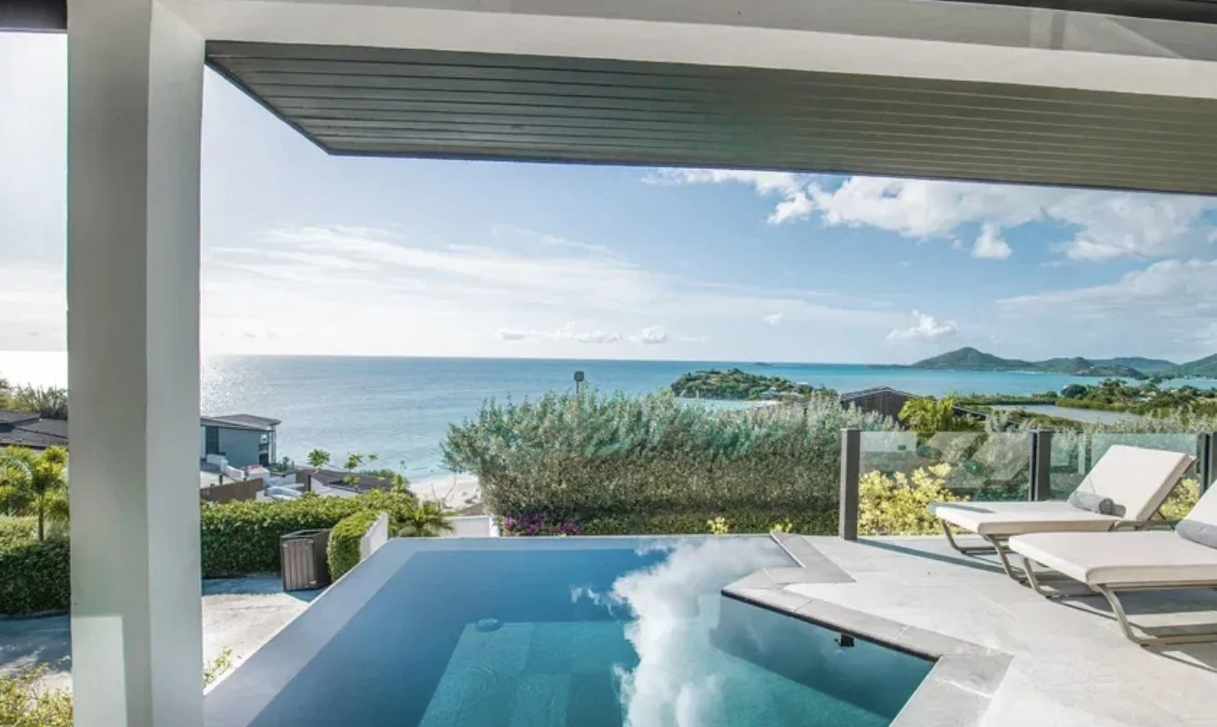 A private plunge pool and loungers overlooking the bay