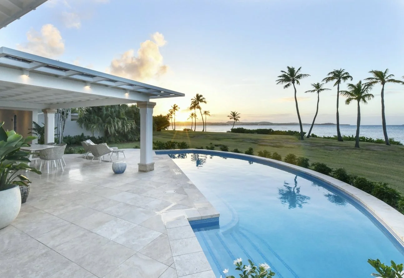 A Signature Ocean Cottage infinity pool at sunset