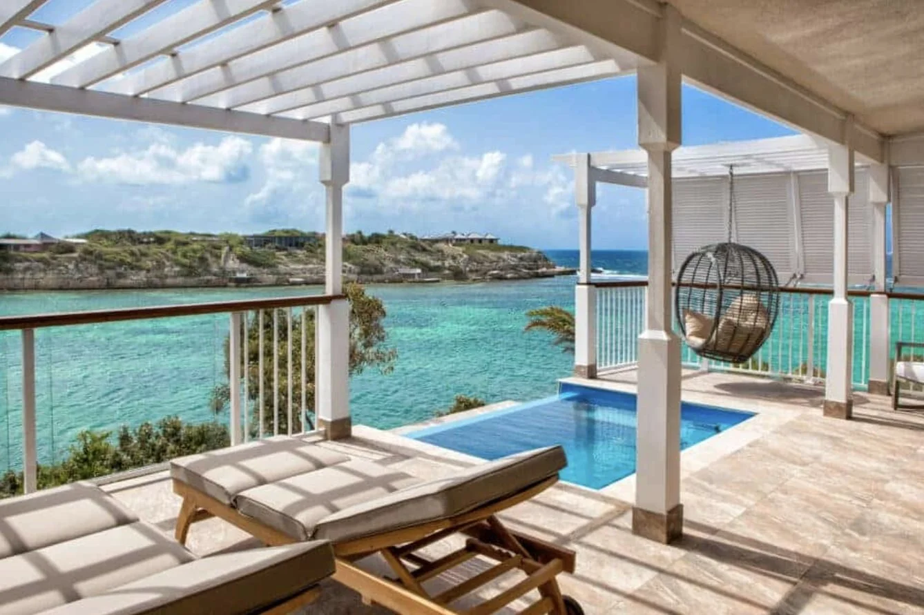 A Hammock Cove villa terrace with plunge pool over a turquoise cove