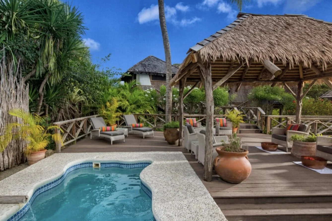 A Gauguin Cottage plunge pool and thatched deck at Galley Bay