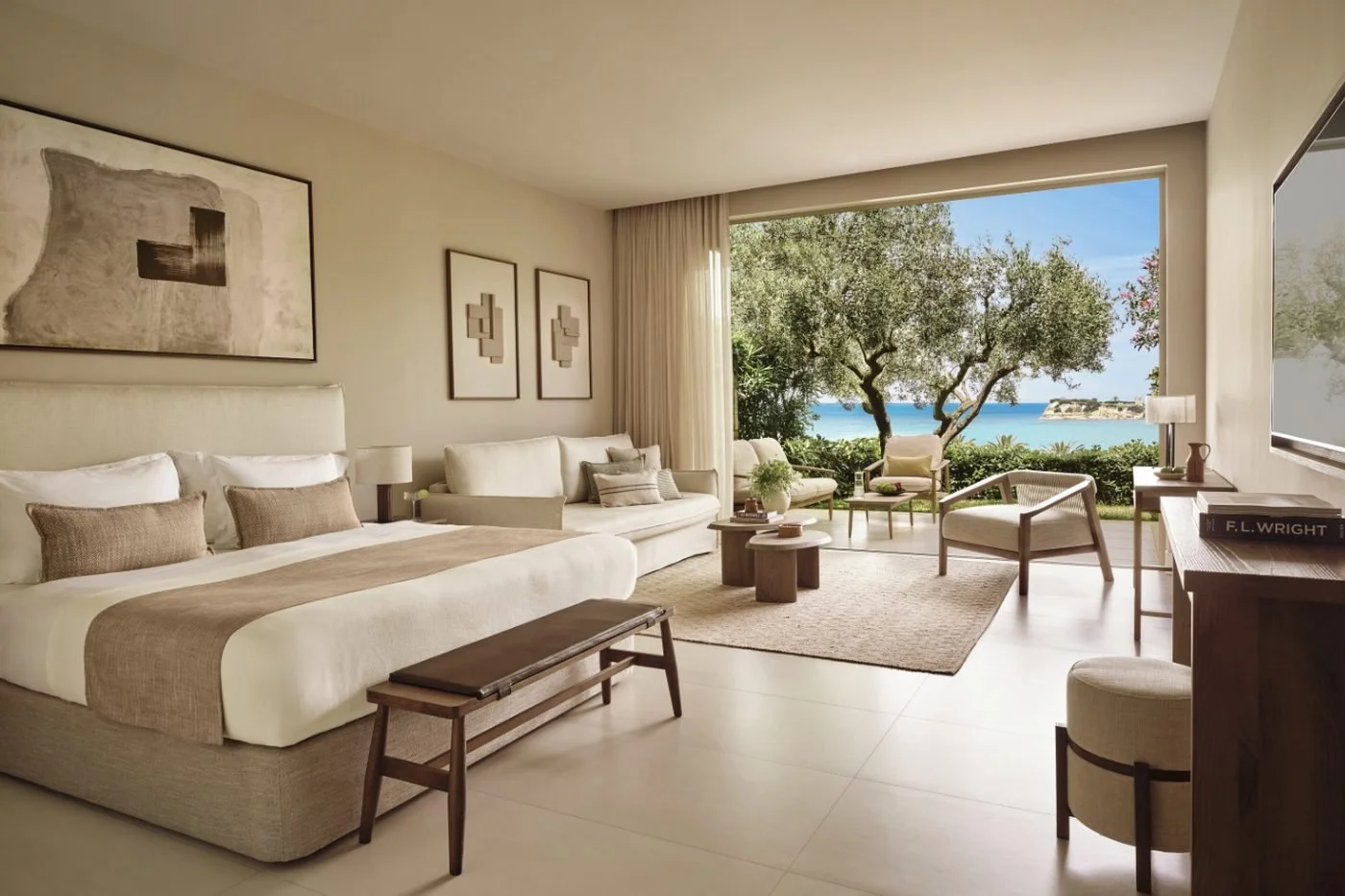 A Junior Suite Private Garden at Sani Club opening onto a garden of olive trees, with the sea beyond