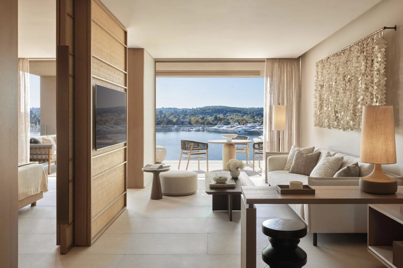 Living room of a one-bedroom residence at Sani Asterias opening onto a balcony over Sani Marina