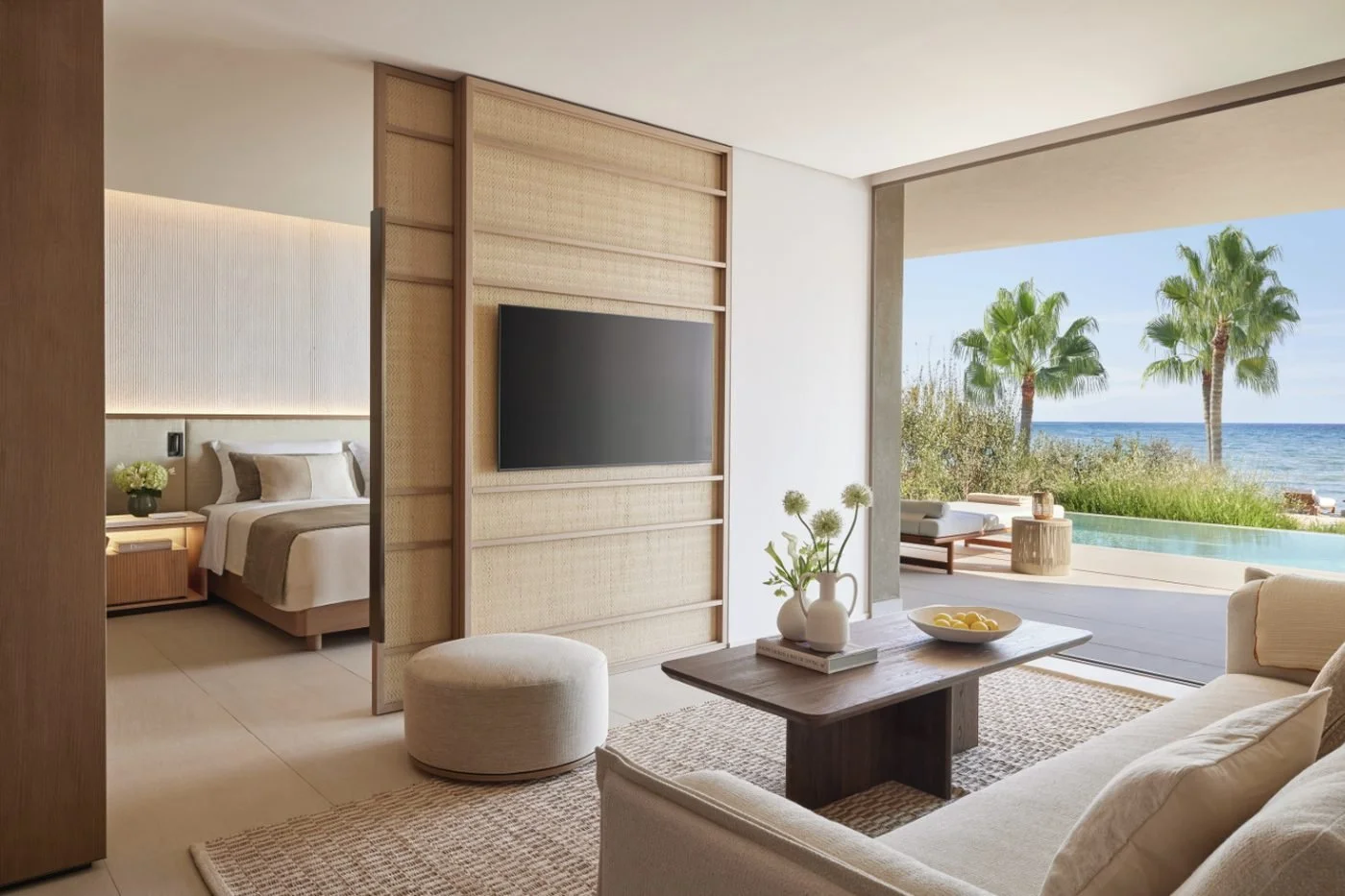 Living room of a residence at Sani Asterias opening onto a terrace, a private infinity pool and the sea