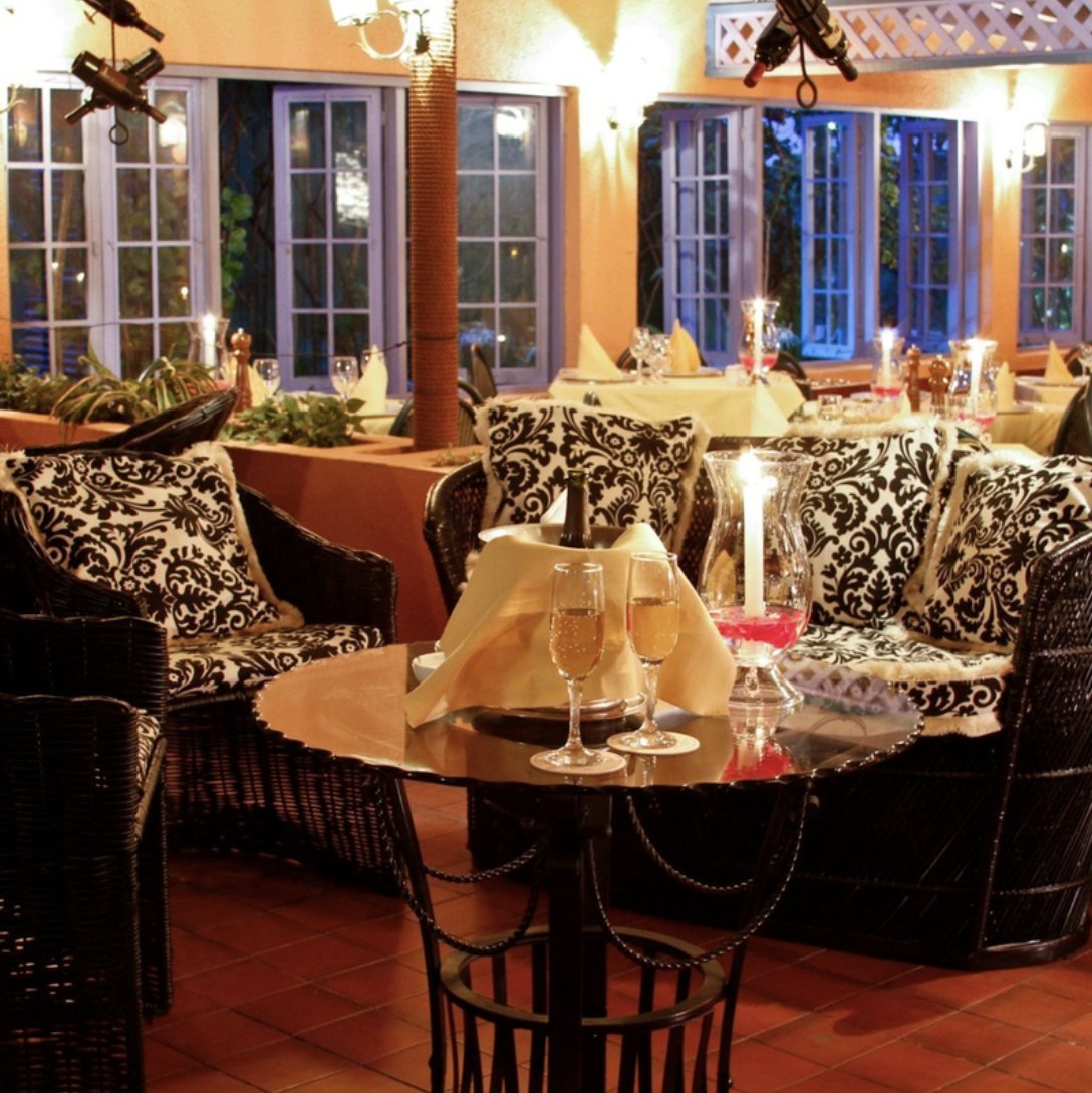 Candlelit tables in the garden room at Le Bistro