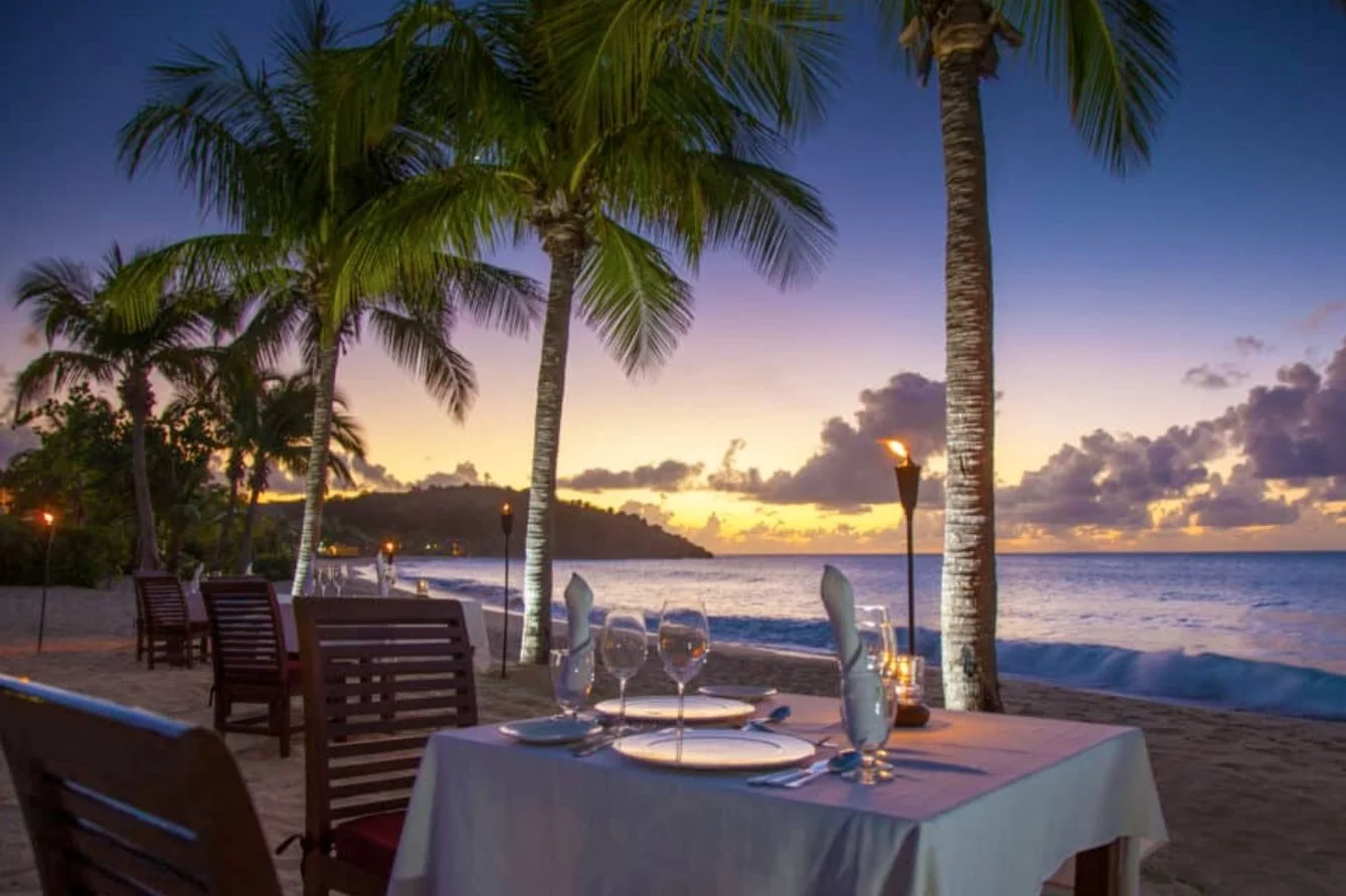 A table for two on the beach at sunset