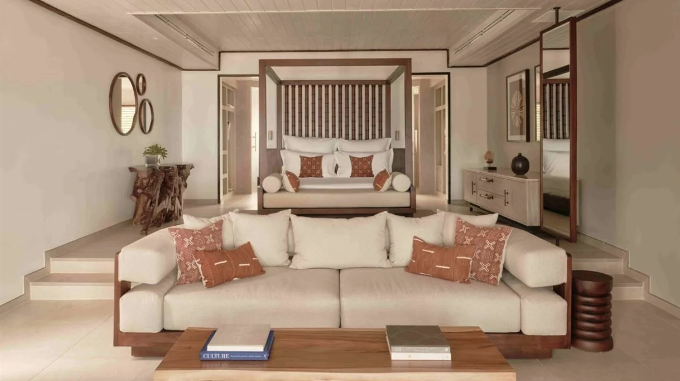 A refurbished suite with a four-poster bed and deep sofa