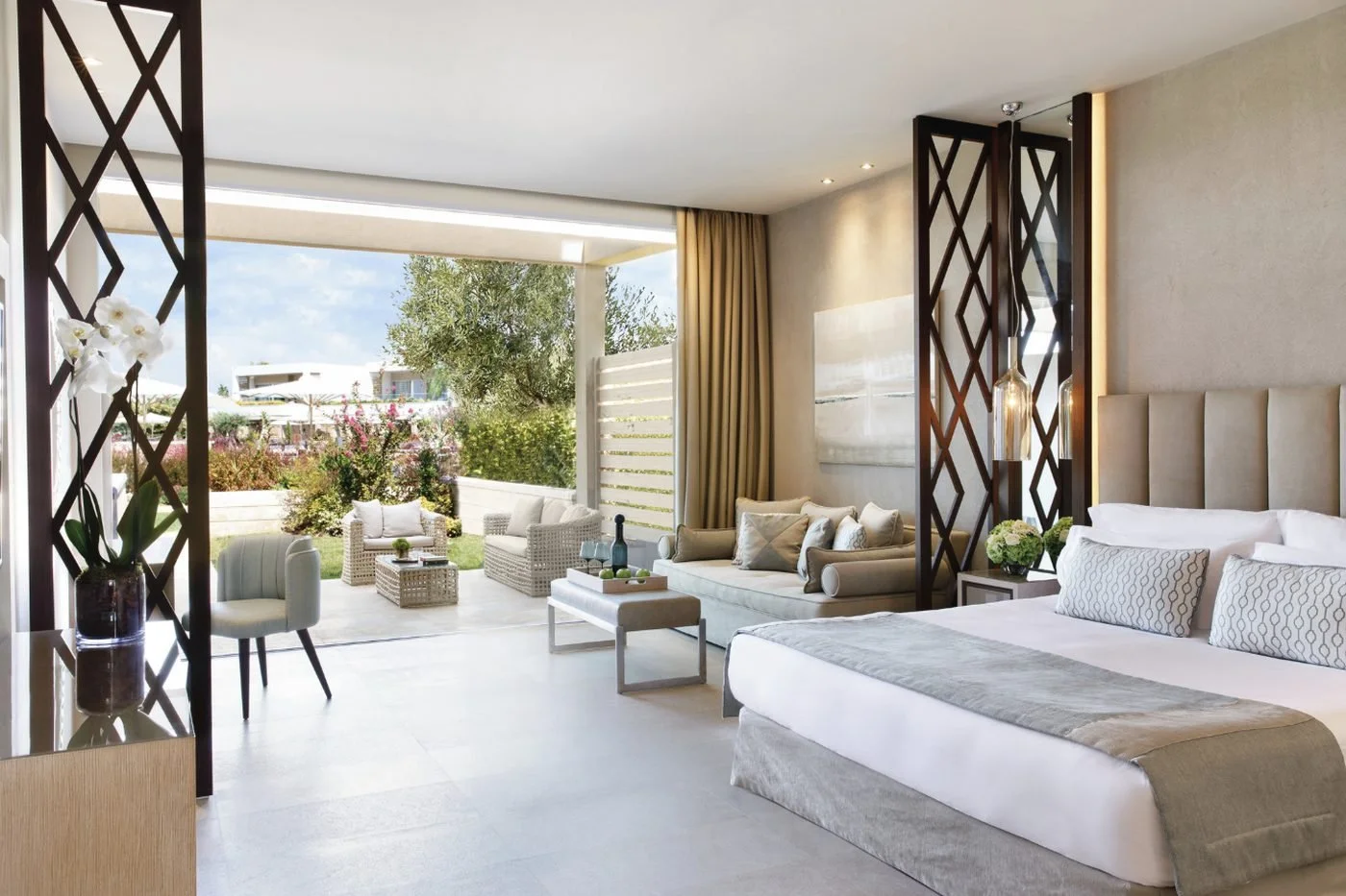 A Junior Suite at Sani Dunes with its sitting area opening onto a garden terrace