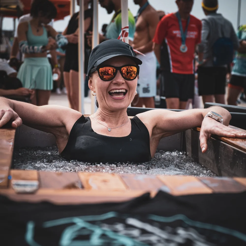 Woman settled into a Pagoc ice bath with ice on the surface