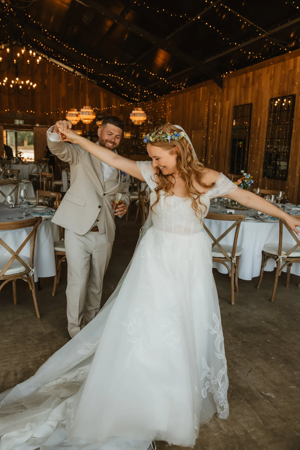 Bride twirling in a rustic barn reception