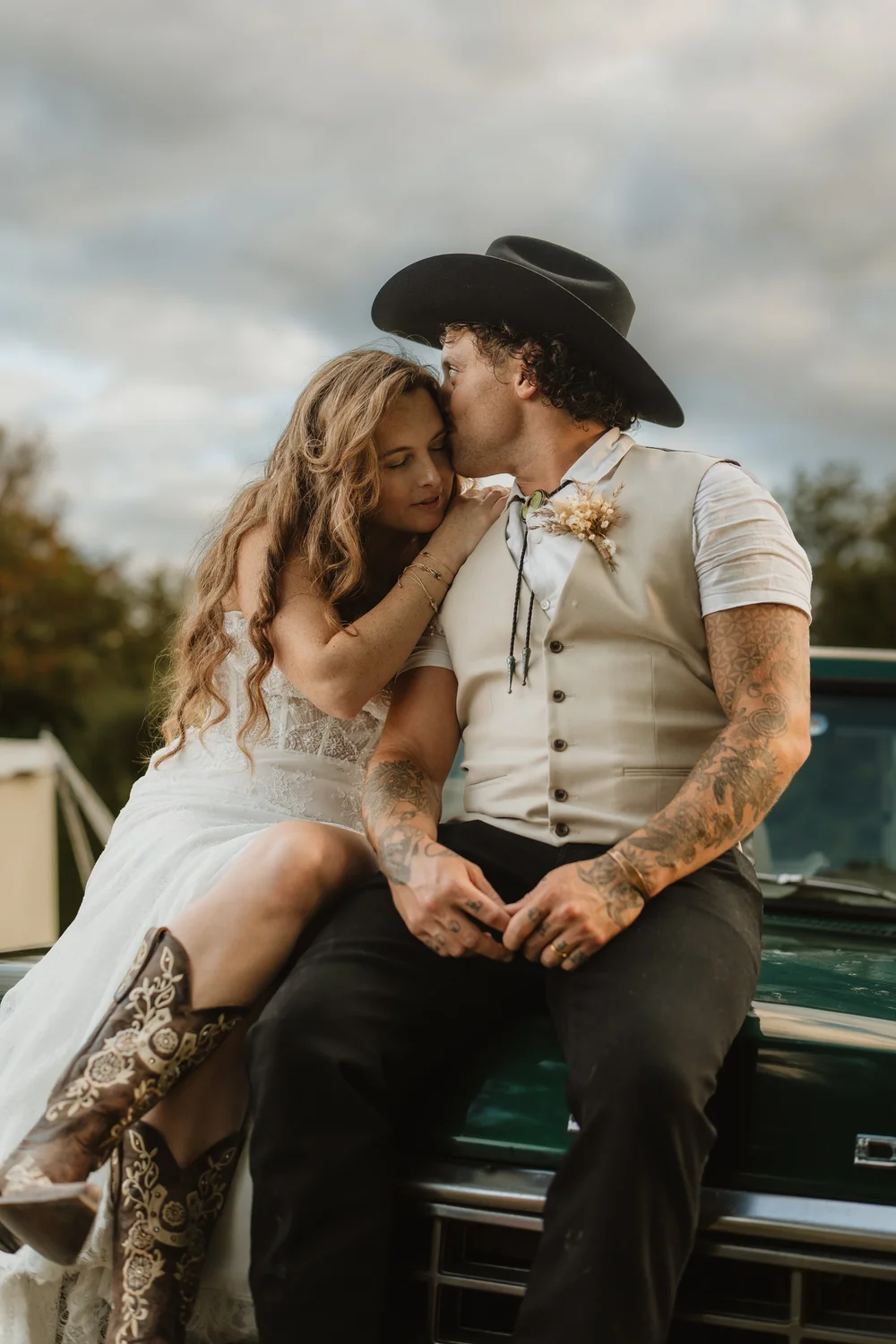 Couple sitting on a classic car bonnet