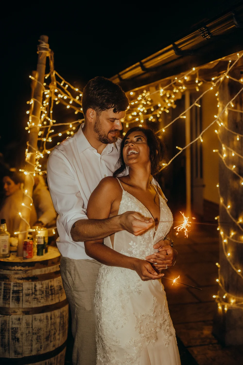 Couple embracing under fairy lights in the evening