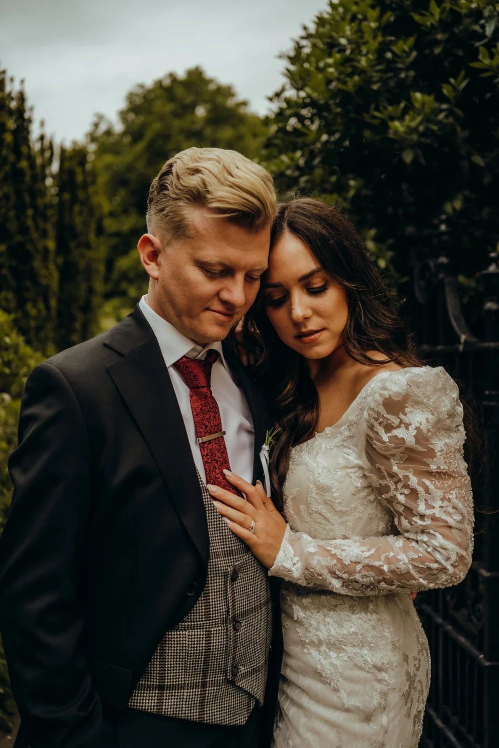Bride and groom embracing in a garden