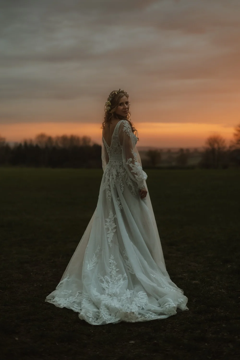Bride at sunset in her lace gown
