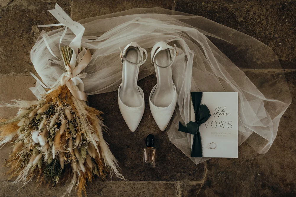 Bridal shoes, veil and dried bouquet on the floor