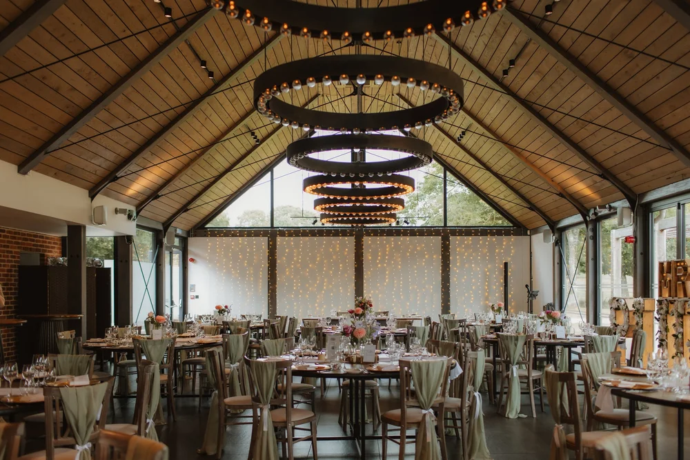 Reception room laid out under statement chandeliers