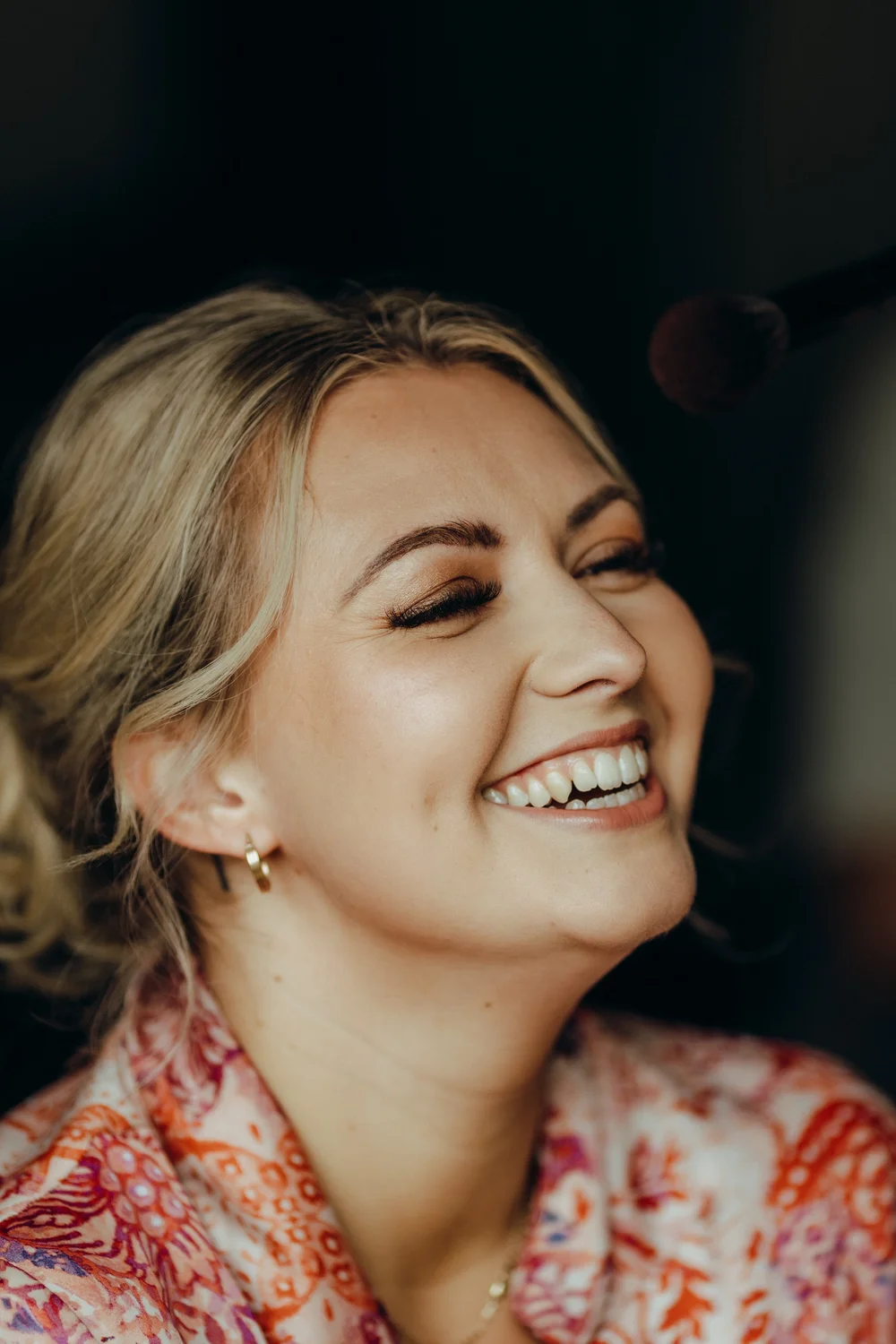 Bride laughing while getting ready