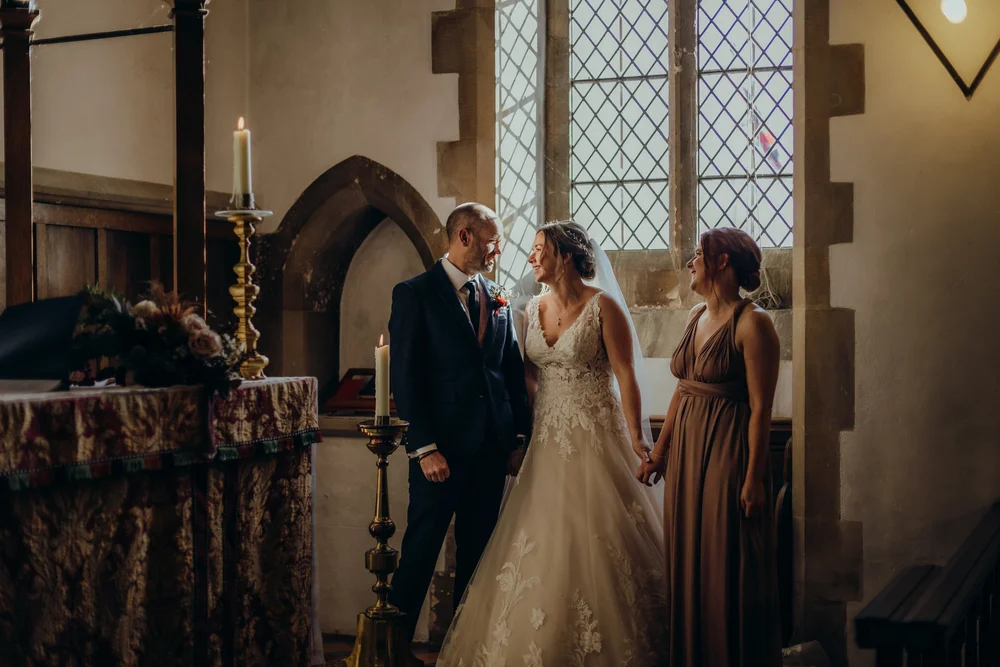 Couple at the altar in a candlelit church