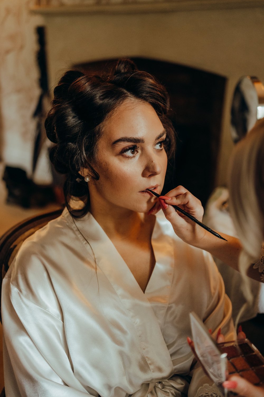 Bride having her make-up done in her robe