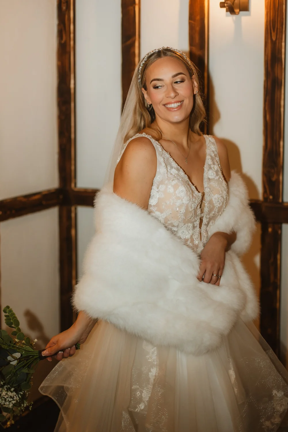 Bride wrapped in a faux-fur stole on a winter wedding day