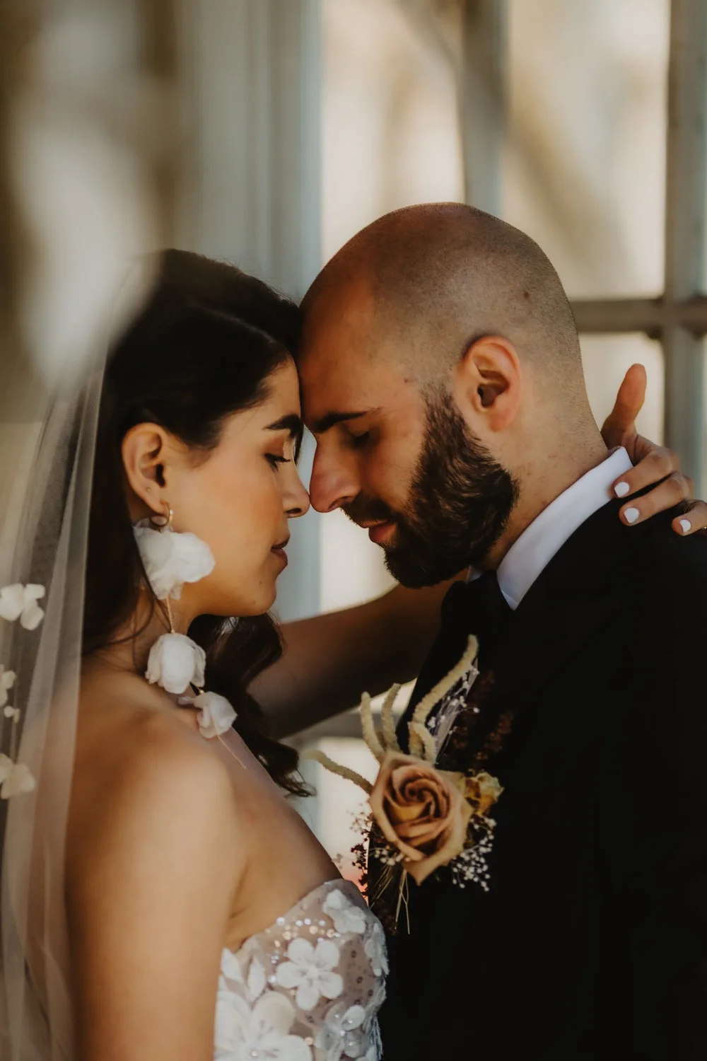 Bride and groom with their foreheads together, eyes closed