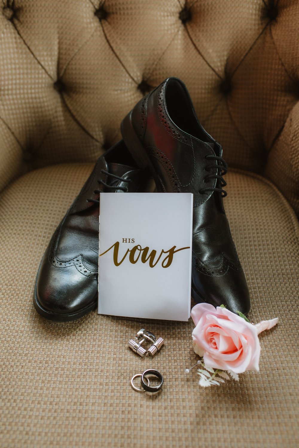 Groom’s shoes, vows card and rings
