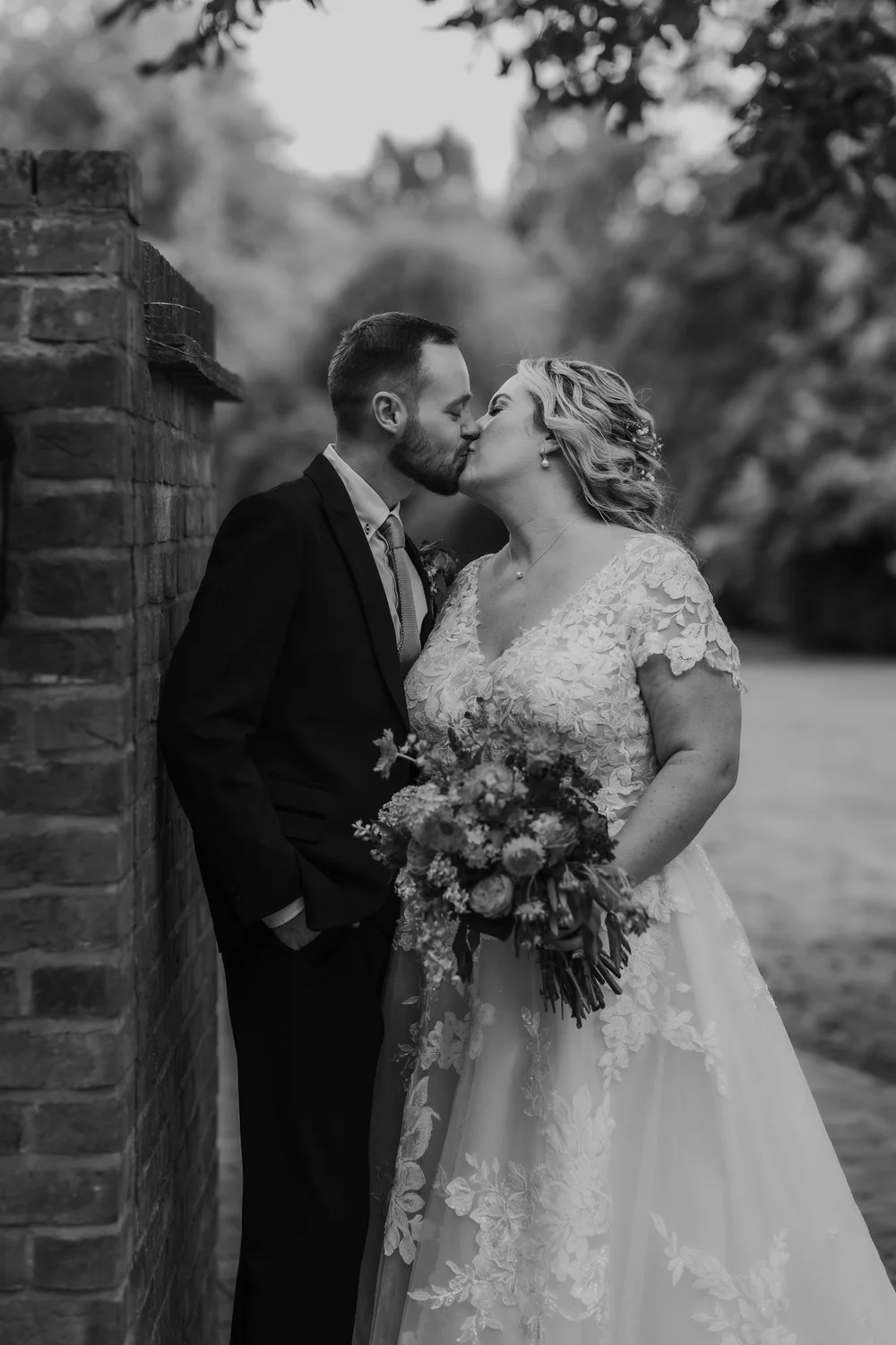 Black and white kiss in a garden doorway