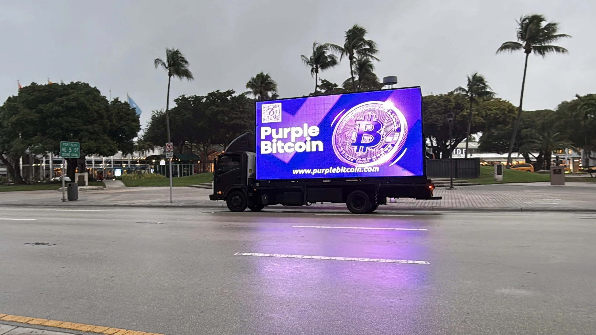 Mobile billboard truck displaying bright evening creative for postgame traffic after the Giants vs. Dolphins preseason matchup