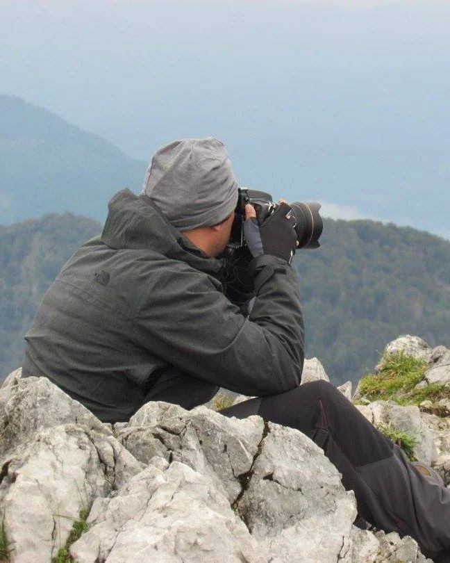 Bachar Bouka photographing wildlife from a mountain ridge