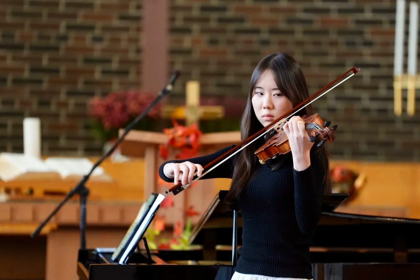Student playing violin during a recital