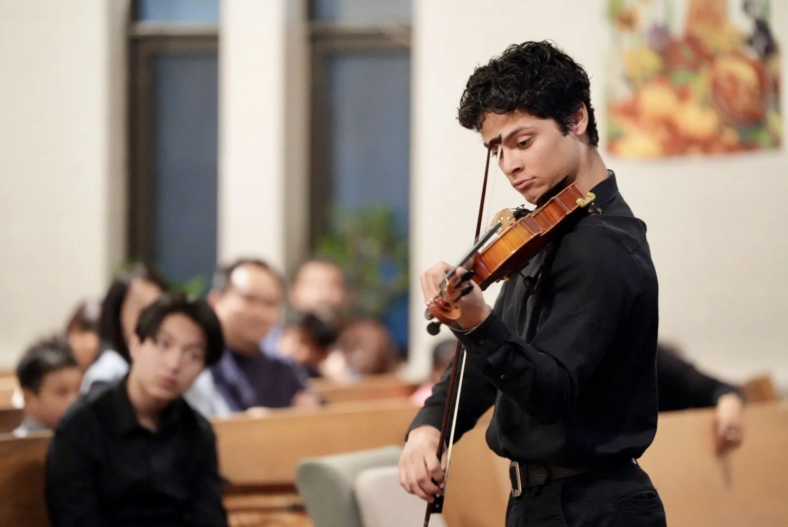 Violin student performing in front of an audience