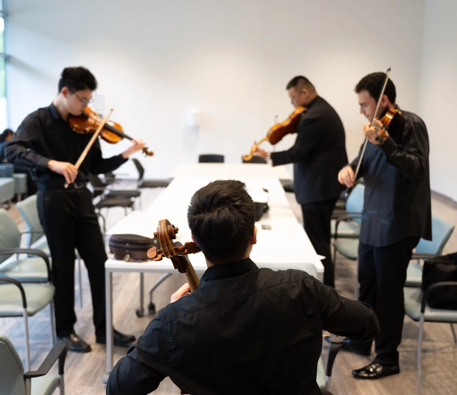 Group of violin students rehearsing together