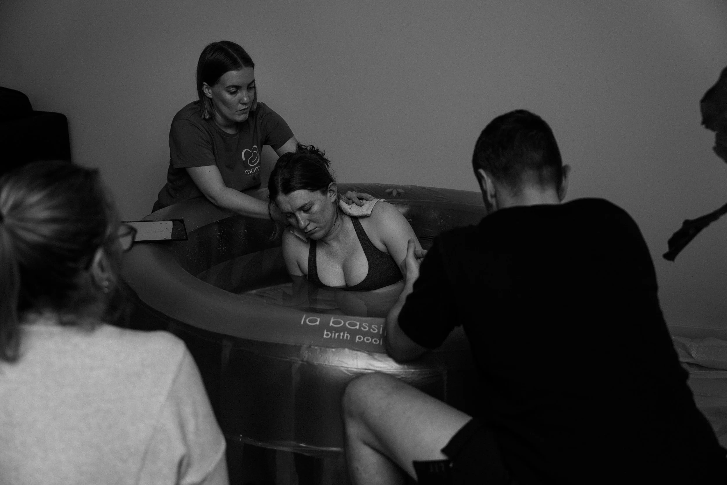 Midwife supporting mother during birth