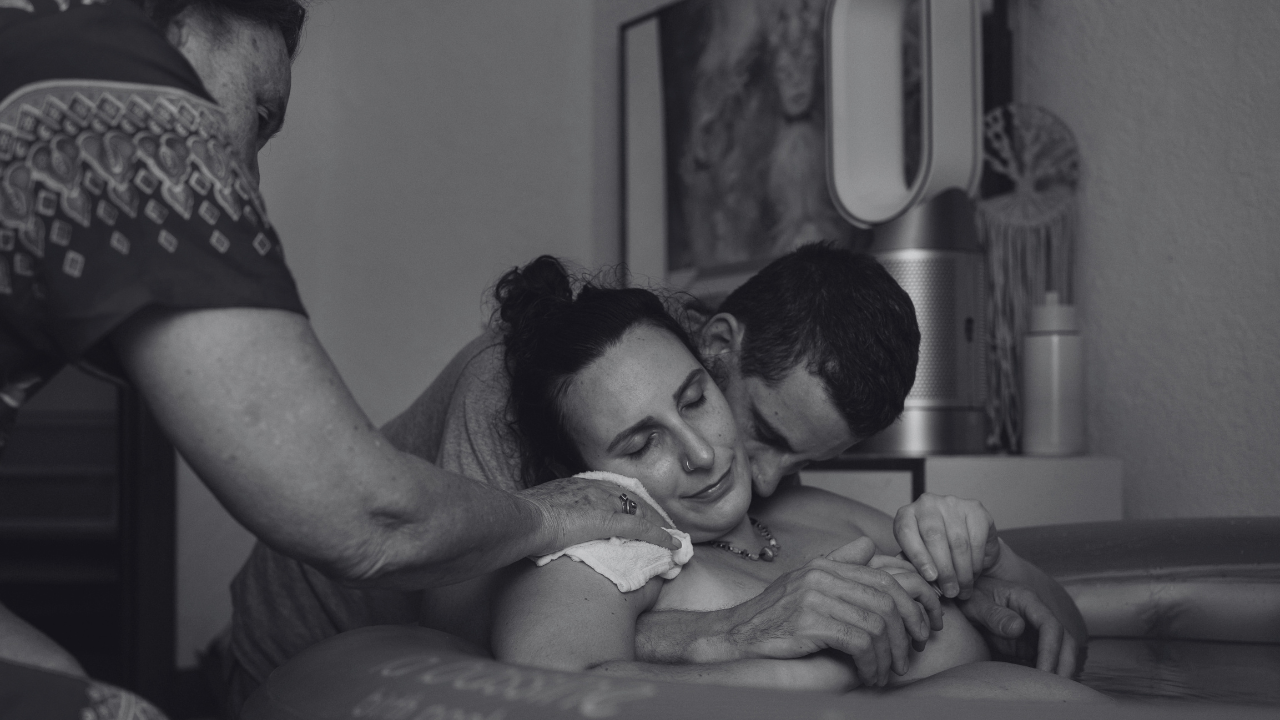 Mother and baby receiving midwifery care